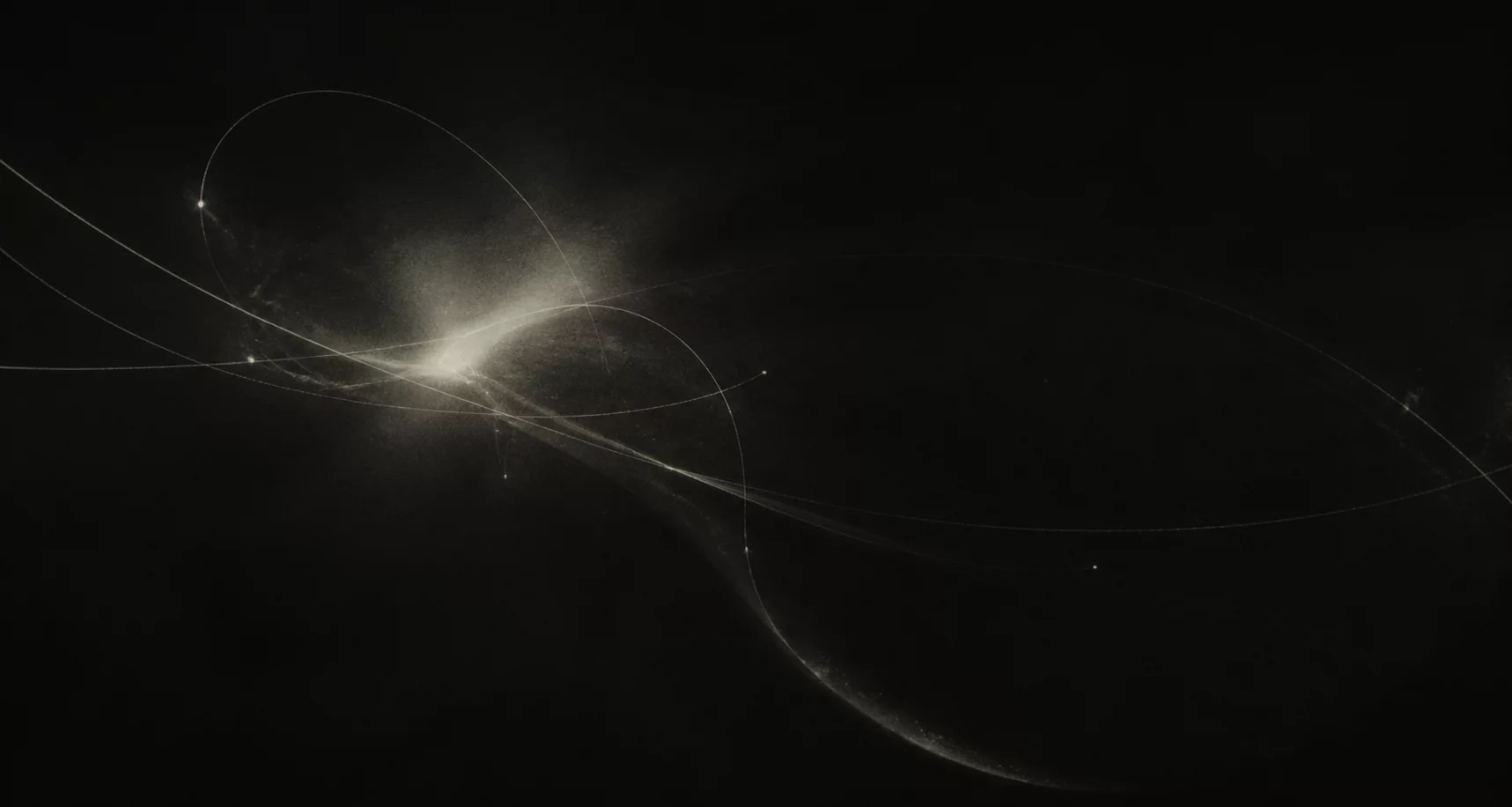 Abstract arcs of light crossing a dark field.